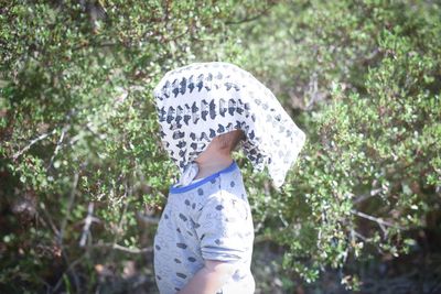 Woman standing on tree trunk