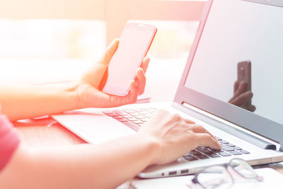 Cropped hand using technologies at desk