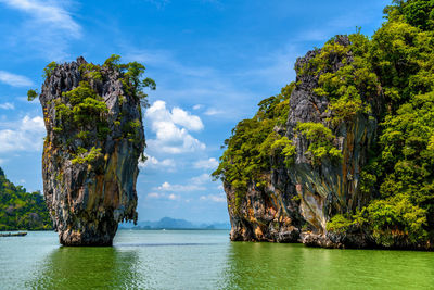 Scenic view of rock formation by sea against sky