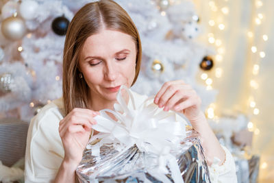 Portrait of young woman blowing confetti