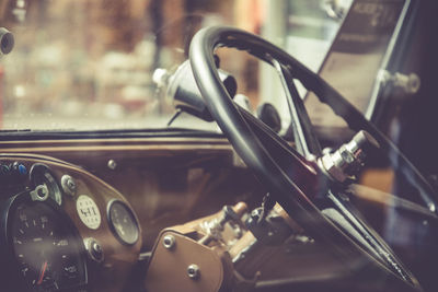 Close-up of steering wheel seen through window