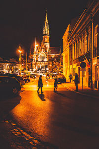 Rear view of people on street at night