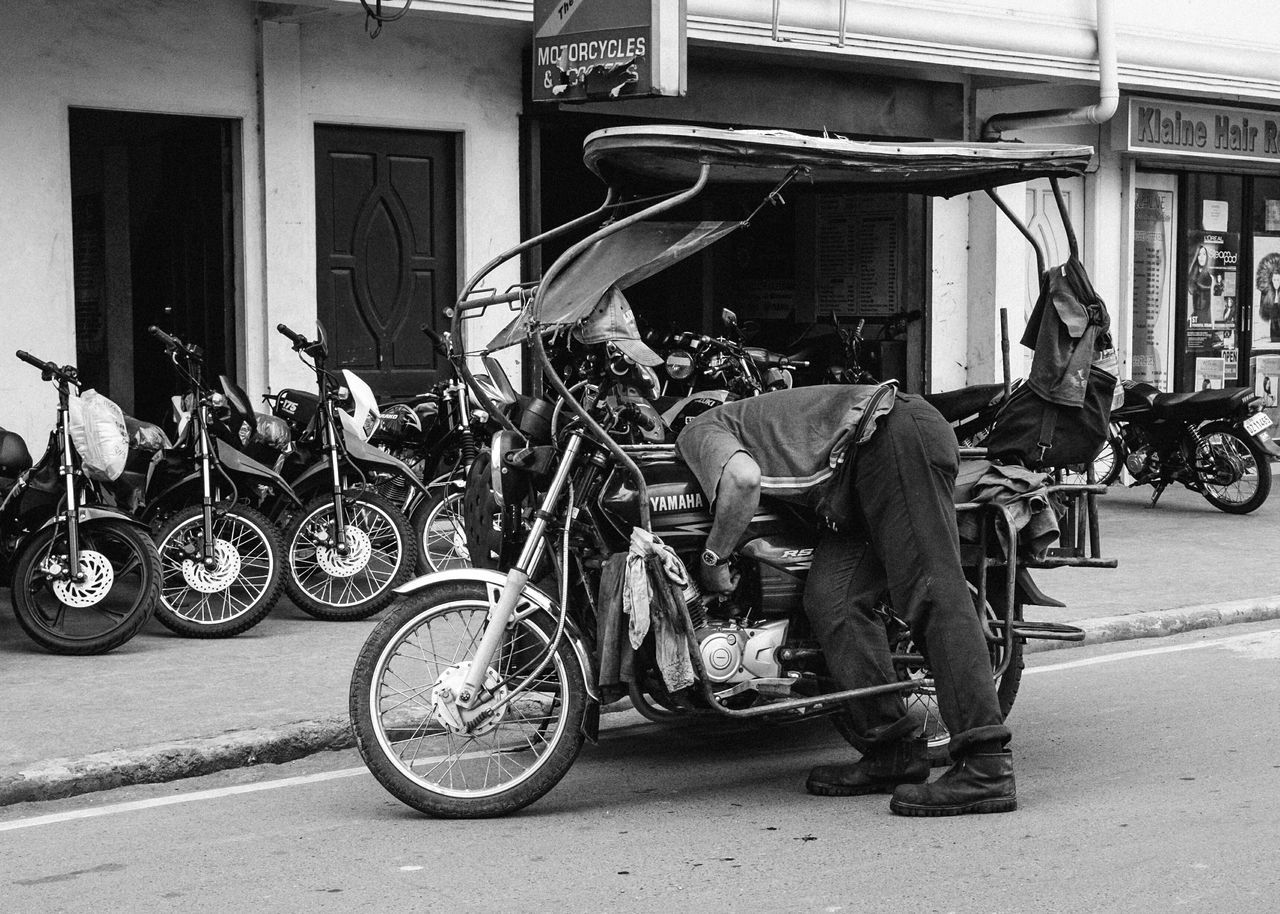 bicycle, transportation, mode of transport, land vehicle, parked, stationary, parking, street, riding, motorcycle, men, travel, building exterior, architecture, cycling, built structure, road, side view