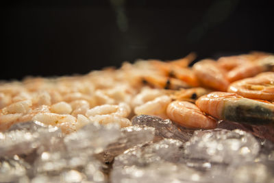 Close-up of meat on table against black background