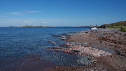 Scenic view of sea against blue sky