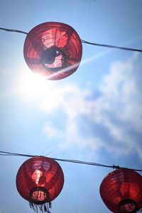 Low angle view of lantern hanging against sky