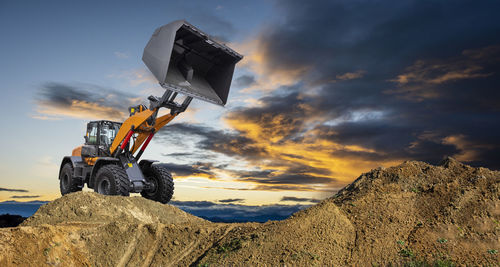 Heavy earth mover bulldozer working on construction site