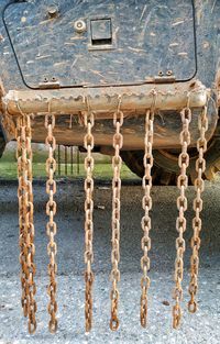 Close-up of rusty chains hanging on truck