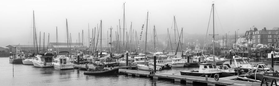 Boats moored at harbor