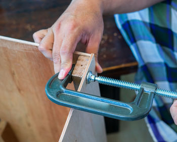 Woodworking. wood working project on work bench, with c-clamps and bar clamp.