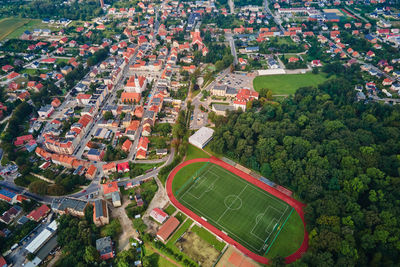Aerial view of small european town with football field and park