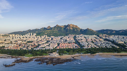 Townscape by sea against sky