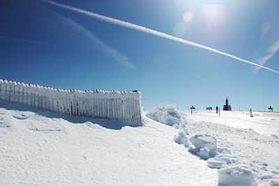 Panoramic view of snow covered landscape against clear sky