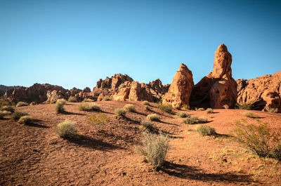 Rock formations against clear blue sky