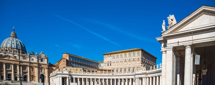 Low angle view of buildings against blue sky