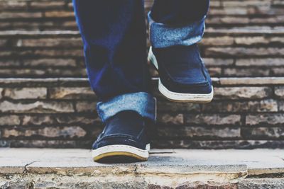 Low section of man standing on staircase