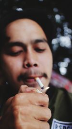 Close-up portrait of woman smoking cigarette