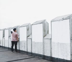 Rear view of men standing against sky