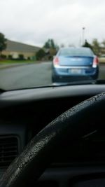 Close-up of car on road