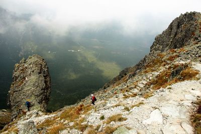 High angle view of man and woman hiking on mountain