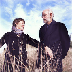 Portrait of senior couple standing on field