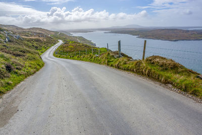 Road by sea against sky