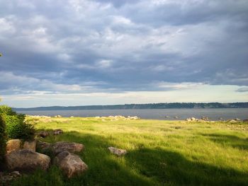 Scenic view of landscape against cloudy sky