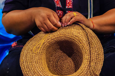 Close-up of woman hands making hat