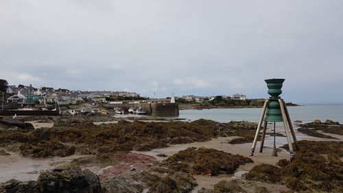 Scenic view of beach by sea against sky