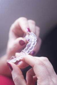 Close-up of hand holding dental aligner