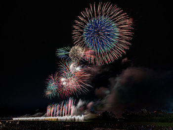 Low angle view of firework display at night