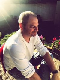 Man sitting by potted plant