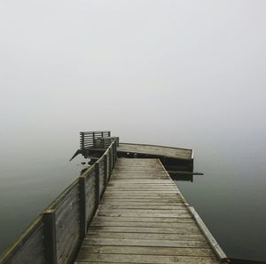 Pier over sea against clear sky