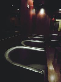 View of empty benches in the dark