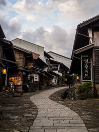 Street amidst buildings against sky