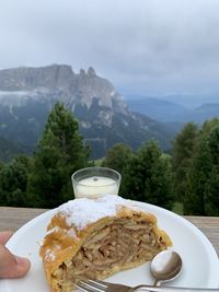 Close-up of coffee on table against mountains