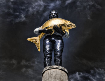 Low angle view of statue against sky