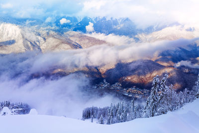 Scenic view of snow covered mountains against sky