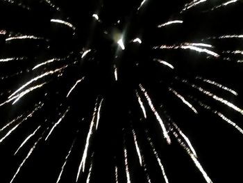 Low angle view of firework display at night