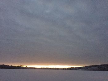 Scenic view of lake against sky at sunset