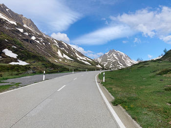 Road amidst mountains against sky