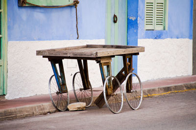 Bicycle on footpath against building