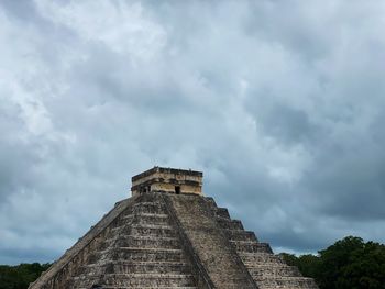 Low angle view of historical building against cloudy sky