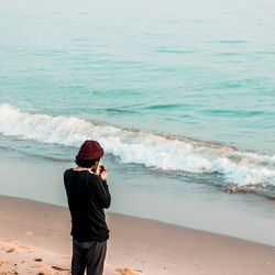 Full length of man photographing sea