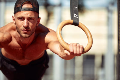 Portrait of young man exercising in gym