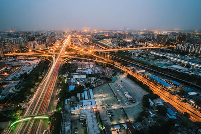 High angle view of illuminated cityscape against sky