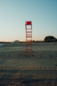 Lifeguard hut on beach against clear sky