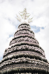 Low angle view of snow covered tree against sky