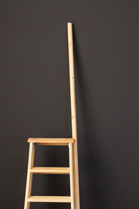 Low angle view of ladder against wall