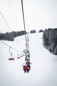 People skiing on snow covered landscape